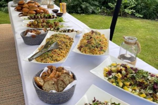 Various salads and breads presented on a long table