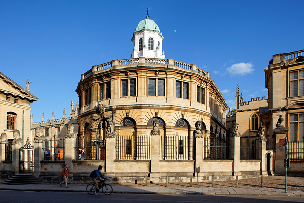 Photo of the exterior of the Sheldonian theatre against a bright blue sky