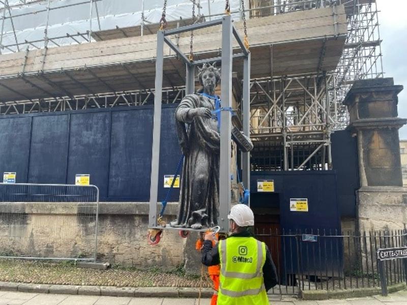 9 a statue is lowered to the ground