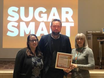 compass team accepts the sugar smart golden teaspoon award