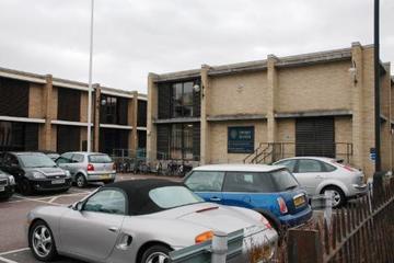 Photo of the exterior of the Ewert House building with full car park in the foreground
